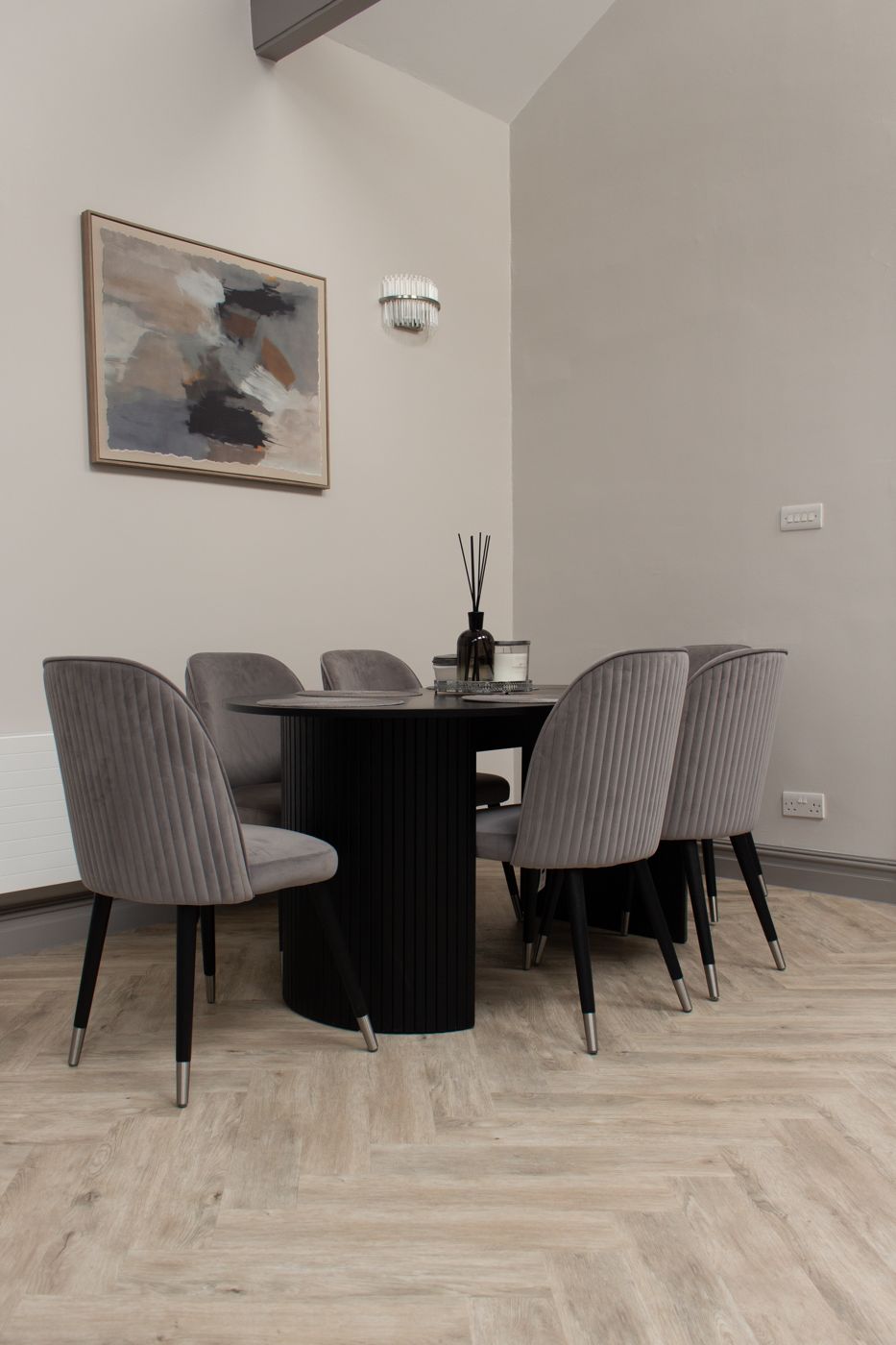 Dining table for six with grey velvet chairs on a herringbone floor, in Dalkeith